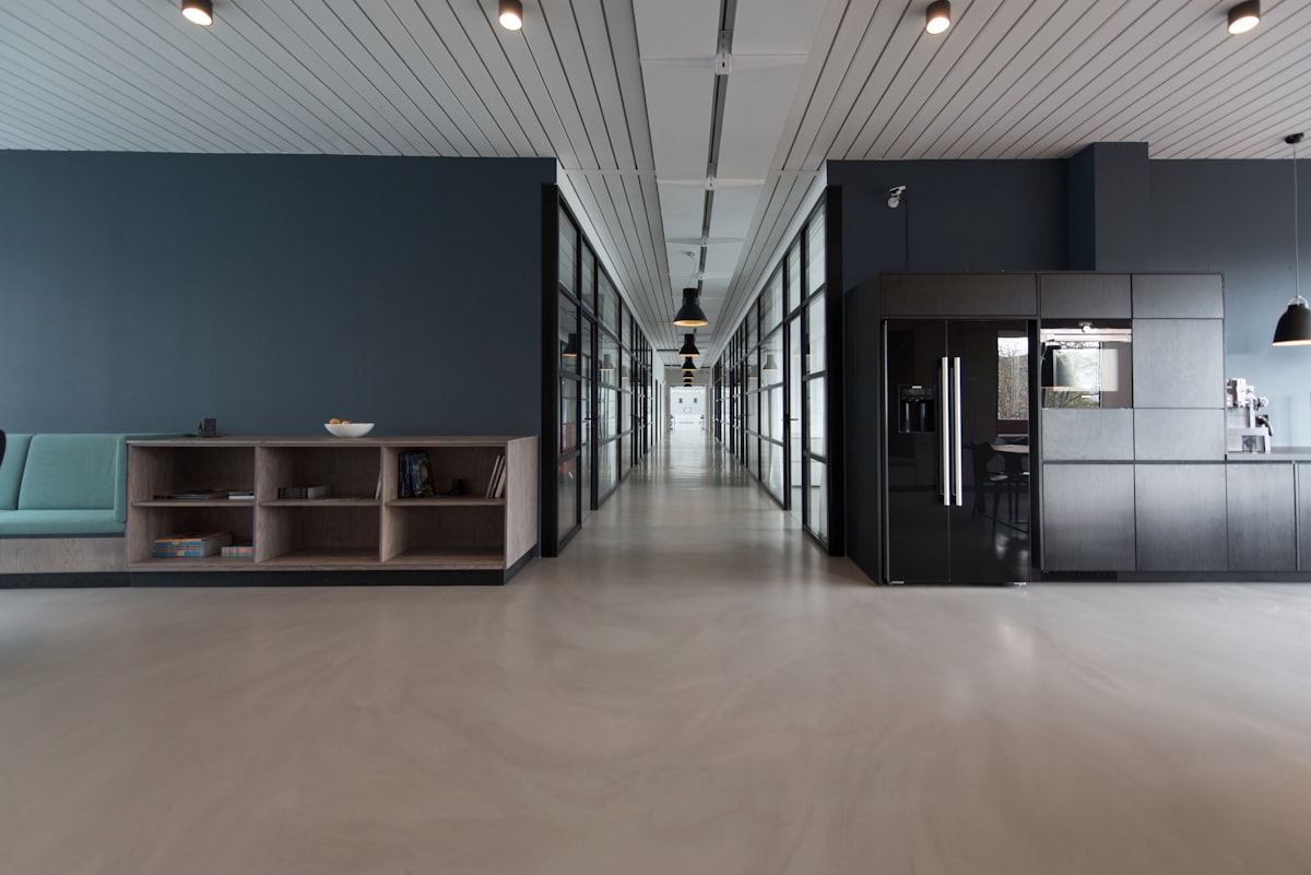 Empty office workspace with rows of desks and no workers